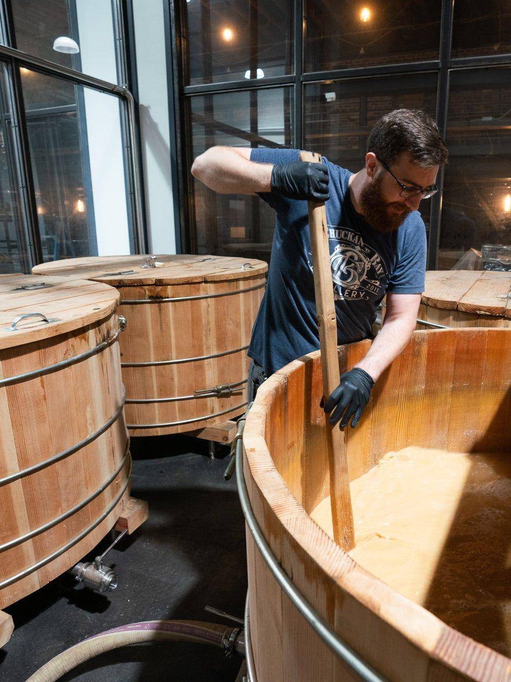 Stirring an open-air ferment in a wooden washback