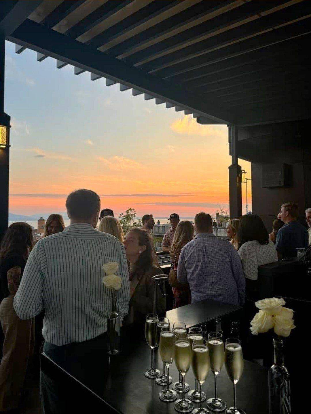 Guests on the rooftop at sunset