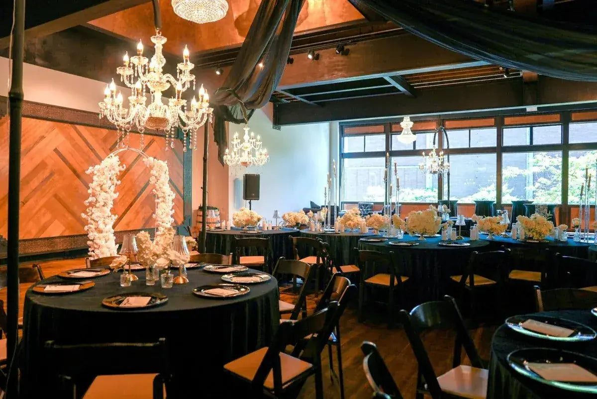 A reception in the ballroom under the chandeliers
