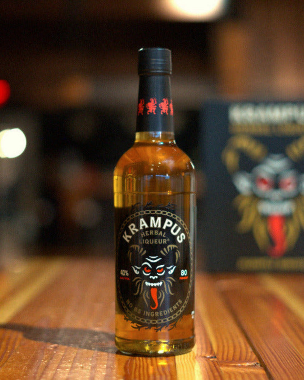 Kampus Liqueur bottle on a wooden surface with a blurred background