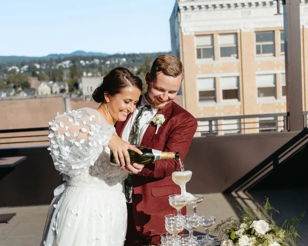A couple pouring champagne on the rooftop